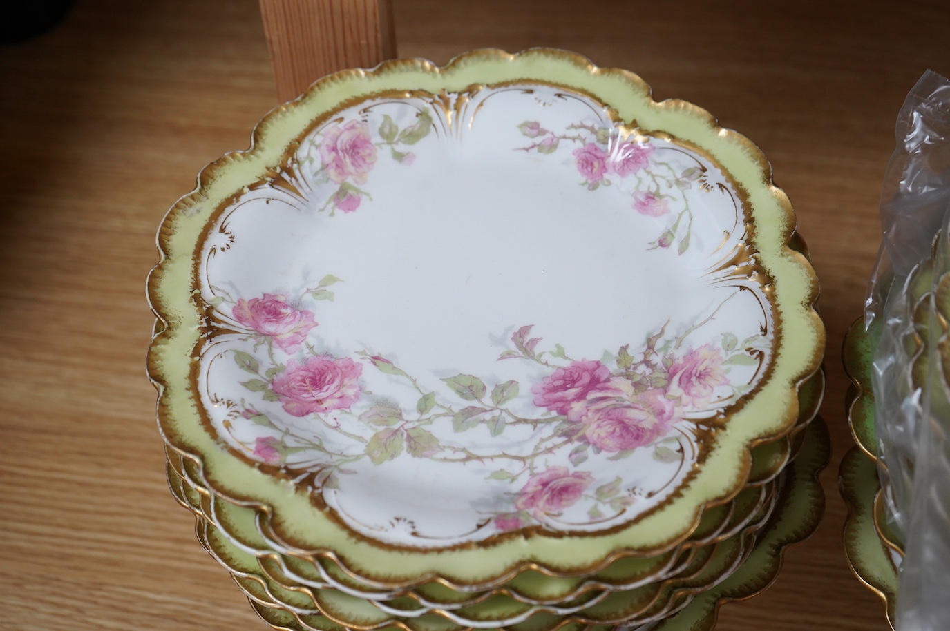 A French porcelain part dessert service together with a set of four Aynsley cups and saucers, the cups with silver holders. Condition - varies, some repairs